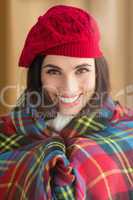 Smiling brunette with cover and red hat