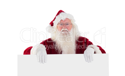 Santa is holding a sign