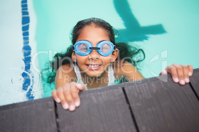 Cute little girl smiling in the pool