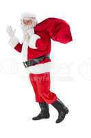 Santa holding a sack and waving