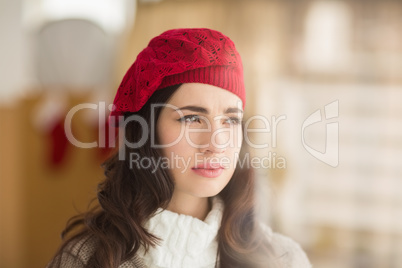 Portrait of brunette with red hat thinking