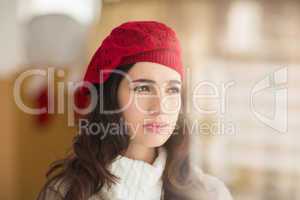 Portrait of brunette with red hat thinking
