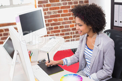 Female photo editor using digitizer in office