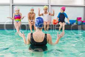 Cute swimming class watching the coach