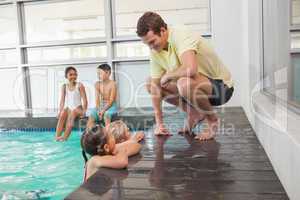 Cute swimming class listening to coach