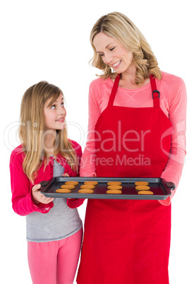 Festive mother and daughter making christmas cookies