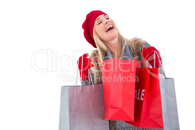 Blonde in winter clothes with shopping bags