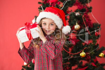 Festive little girl holding gift