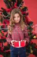 Festive little girl holding a gift