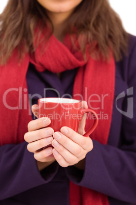 Woman in warm clothing holding mug