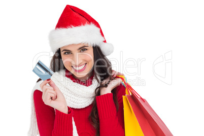 Excited brunette holding shopping bags and credit card