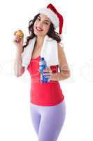 Festive fit brunette holding bottle and apple