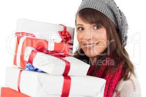 Portrait of a pretty woman holding pile of gifts