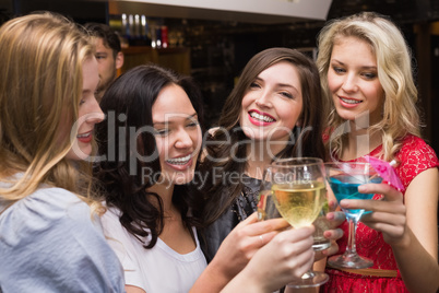 Happy friends having a drink together