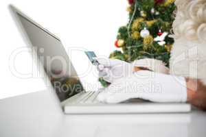 Santa shopping online with laptop