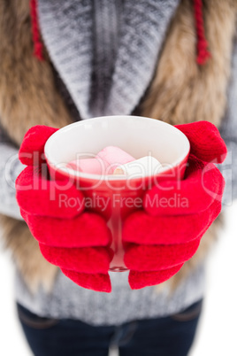 Woman in winter clothes holding a mug