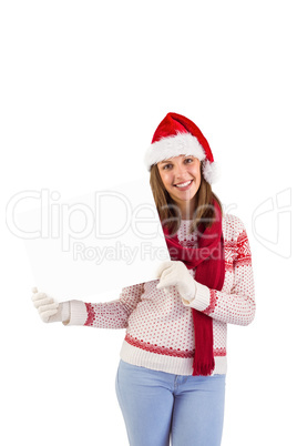Happy brunette in winter clothes showing card