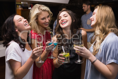 Pretty friends having a drink together