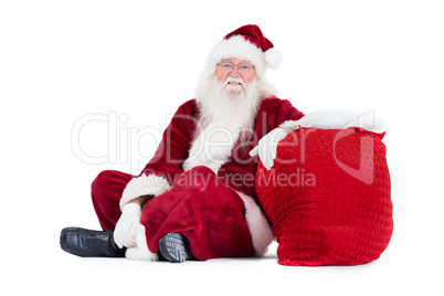 Santa sits next to his bag