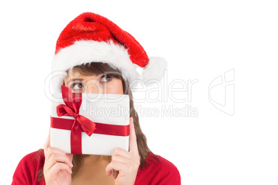 Portrait of a festive young woman holding a gift