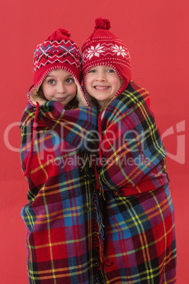 Festive little girls under a blanket