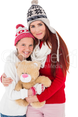 Mother and daughter holding teddy bear