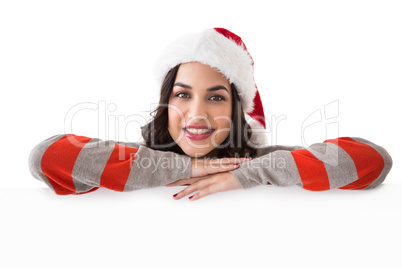 Beauty brunette in santa hat smiling at camera