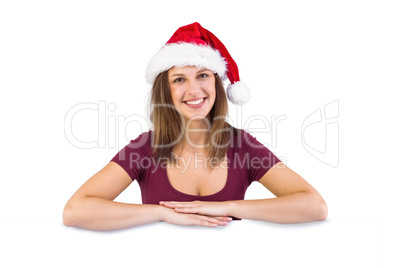 Festive brunette leaning on large poster