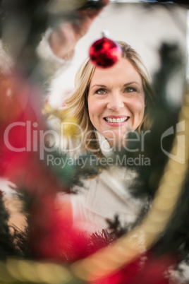 Festive blonde hanging bauble on christmas tree