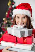 Festive redhead holding christmas gifts