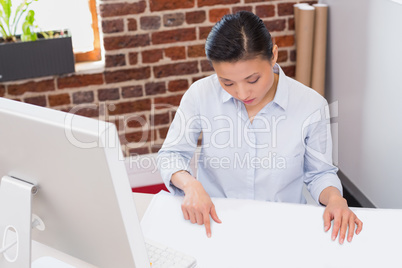 Concentrated woman working at desk