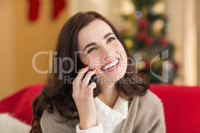 Smiling brunette on the phone on christmas day