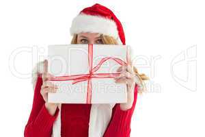 Blonde woman hiding behind a gift