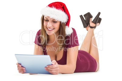 Festive brunette using tablet pc