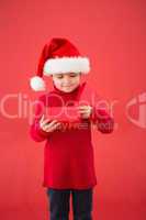 Festive little boy opening a gift