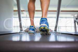 Low section of a man running on treadmill