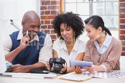 Photo editors looking at camera in office