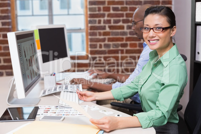 Smiling female photo editor in office