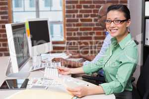 Smiling female photo editor in office