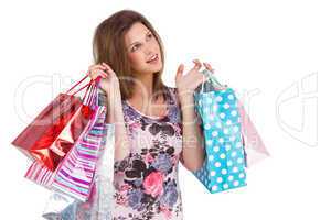 Thinking cute brunette holding shopping bags