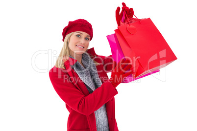 Blonde in winter clothes holding shopping bags