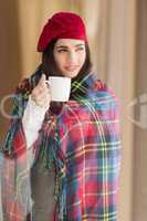 Brunette with cover holding mug and thinking