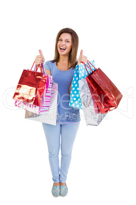 Woman showing shopping bags with the thumbs up