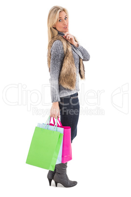 Blonde in winter clothes holding shopping bags