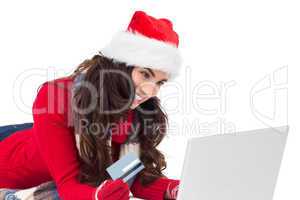 Happy brunette shopping online with laptop