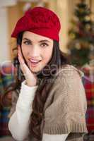 Surprised brunette on the couch at christmas