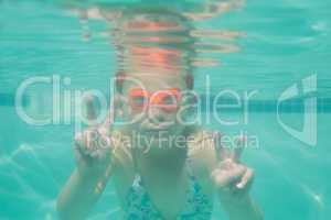 Cute kid posing underwater in pool