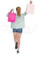 Rear view of young woman with shopping bags