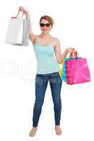 Woman holding shopping bags wearing sunglasses