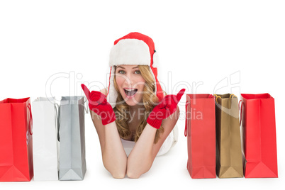 Happy woman lying between shopping bags